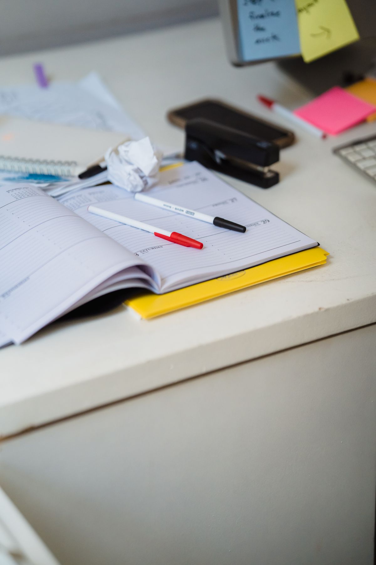 Planner and pens on an organized desk representing an admin and daily task AI agent