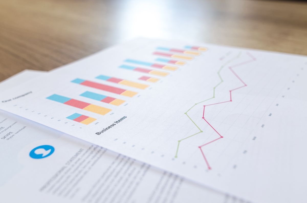 Business performance charts and graphs printed on paper for a reporting agent summary