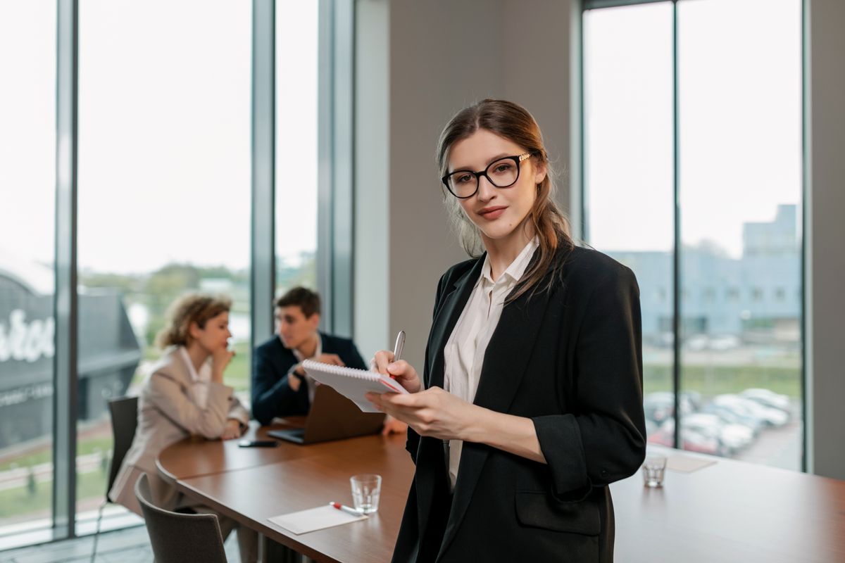 Business professional holding a notebook while preparing sales and offer messages for customers