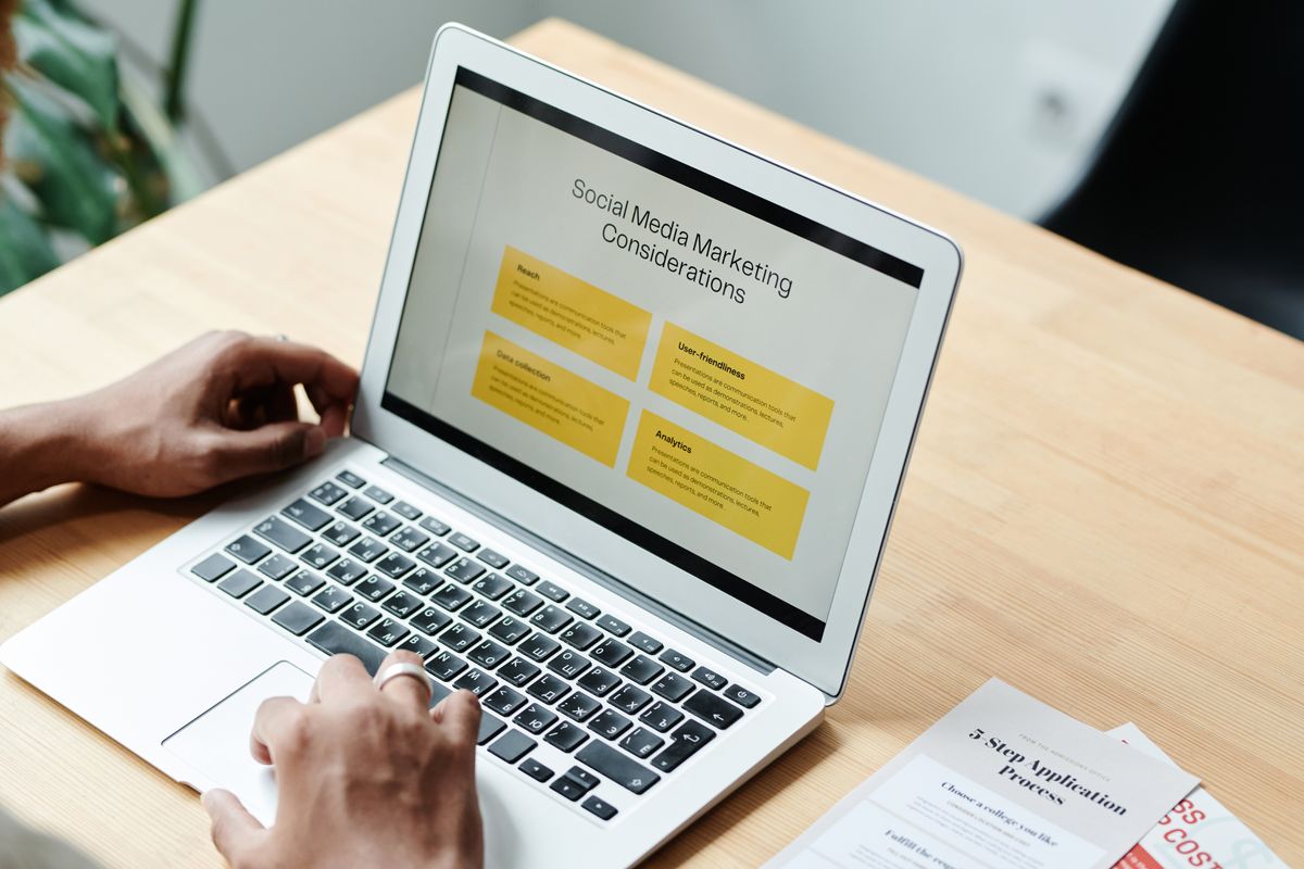 Person planning social media marketing content on a laptop for a small business