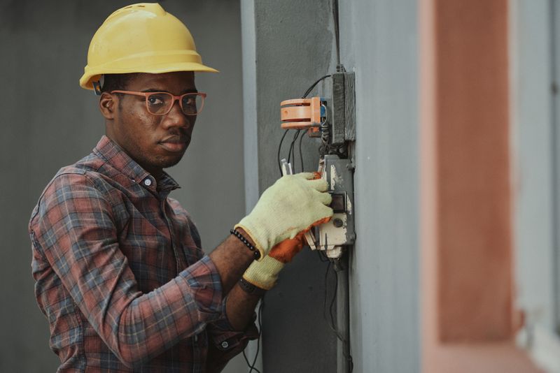 Electrician testing electrical socket and switch safety in house