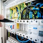Electrician working on circuit breaker panel and wiring in Dehradun
