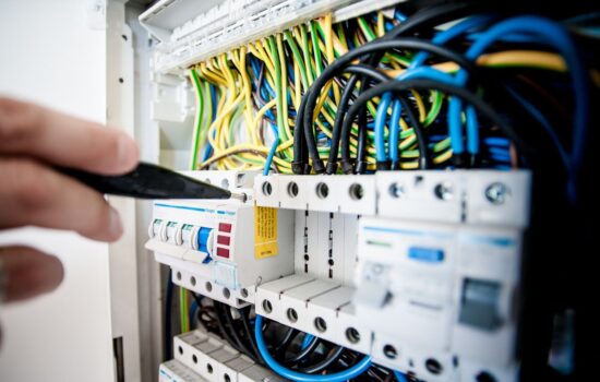 Electrician working on circuit breaker panel and wiring in Dehradun